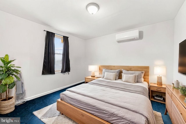 carpeted bedroom featuring baseboards and a wall mounted AC