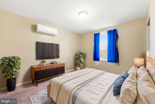 bedroom featuring a wall unit AC, light colored carpet, and baseboards