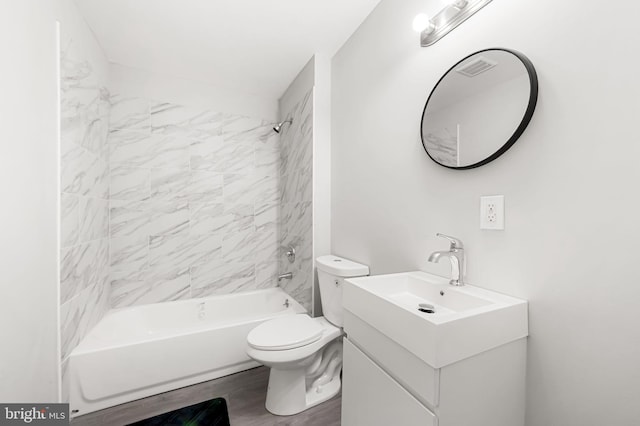 bathroom with vanity, wood finished floors, washtub / shower combination, visible vents, and toilet