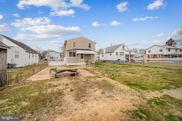 rear view of house featuring a residential view, a fenced backyard, and entry steps