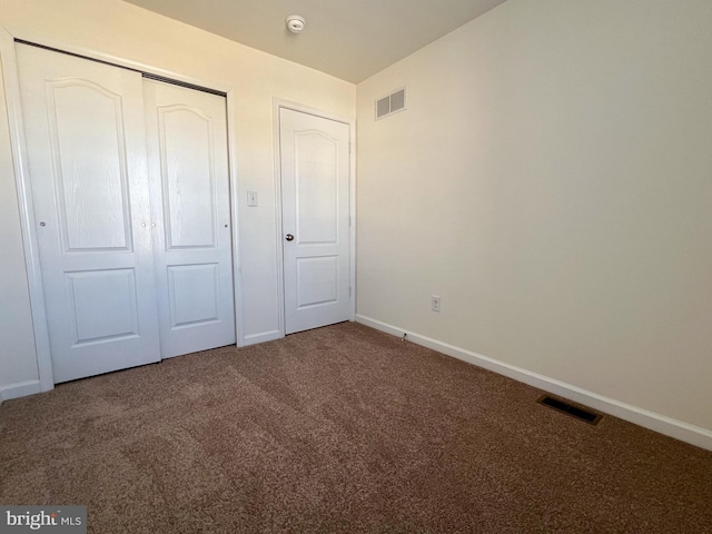 unfurnished bedroom featuring a closet, visible vents, carpet flooring, and baseboards