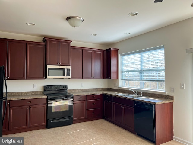 kitchen featuring a sink, dark countertops, black appliances, and recessed lighting