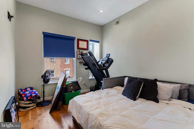 bedroom featuring recessed lighting, baseboards, visible vents, and wood-type flooring