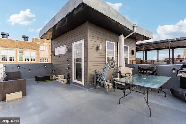 view of patio with outdoor dining space and grilling area