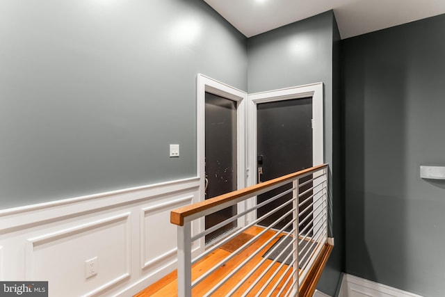 interior space with a decorative wall and wainscoting