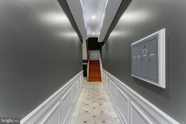 hall featuring a decorative wall, recessed lighting, mail area, and a wainscoted wall