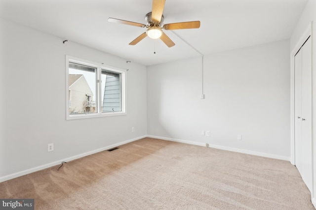 unfurnished bedroom with visible vents, a ceiling fan, a closet, carpet floors, and baseboards