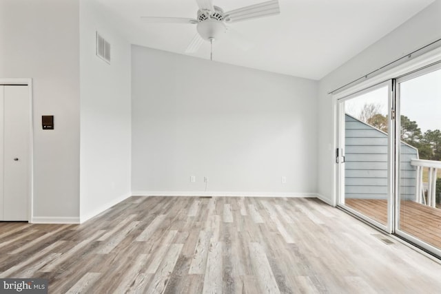 empty room with ceiling fan, visible vents, baseboards, and wood finished floors