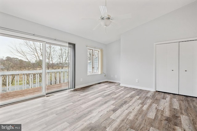 unfurnished bedroom featuring access to exterior, visible vents, ceiling fan, baseboards, and wood finished floors