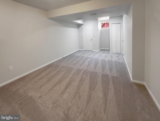 finished below grade area with baseboards and carpet floors