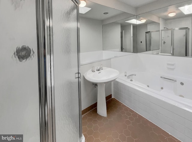 full bath with a tub with jets, a stall shower, and tile patterned flooring