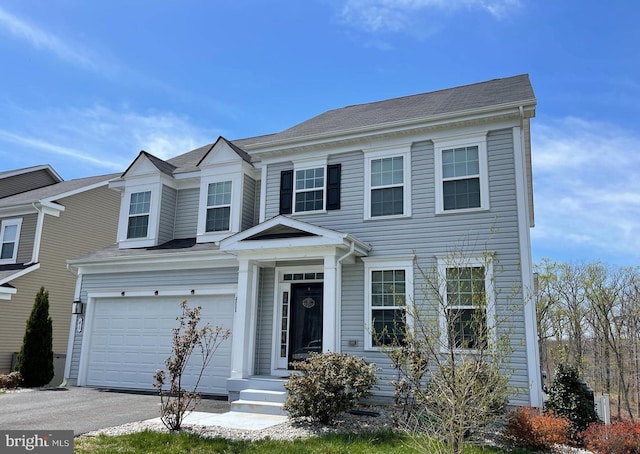 view of front of home featuring aphalt driveway and an attached garage