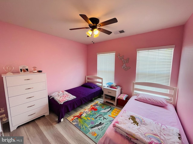 bedroom with visible vents, ceiling fan, and light wood finished floors