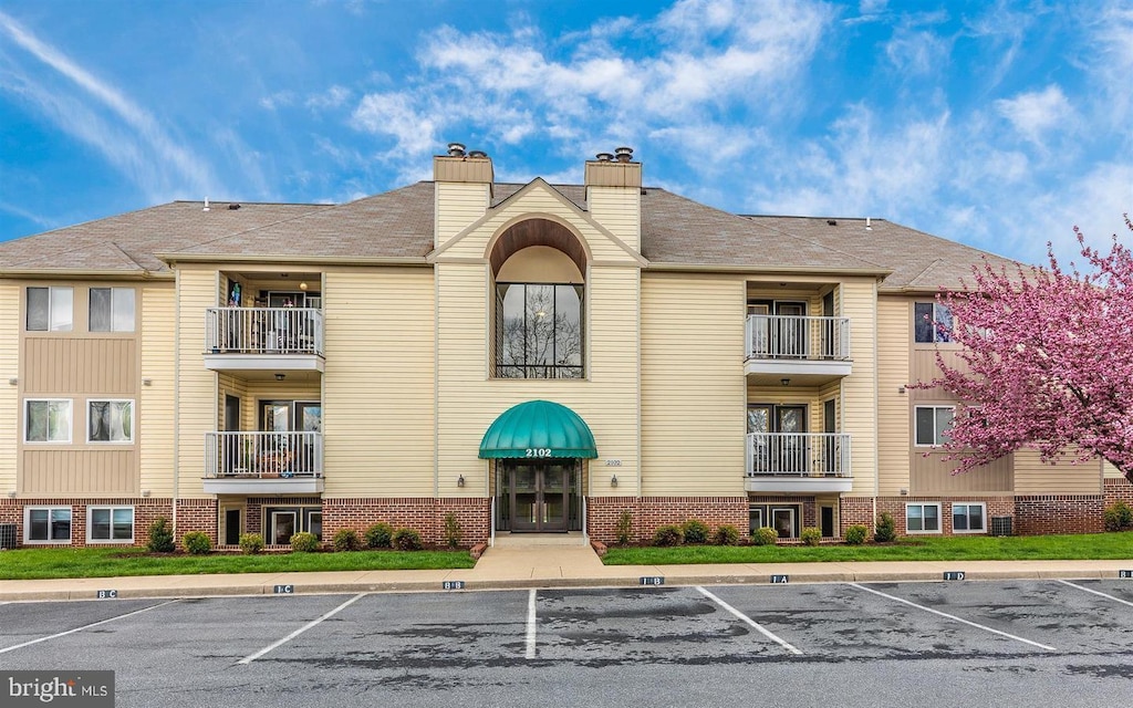 view of property with uncovered parking