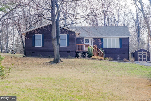 view of front facade featuring crawl space, a storage shed, an outdoor structure, and a front yard