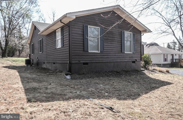 view of property exterior with crawl space and cooling unit