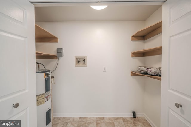 laundry area with washer hookup, laundry area, baseboards, and water heater