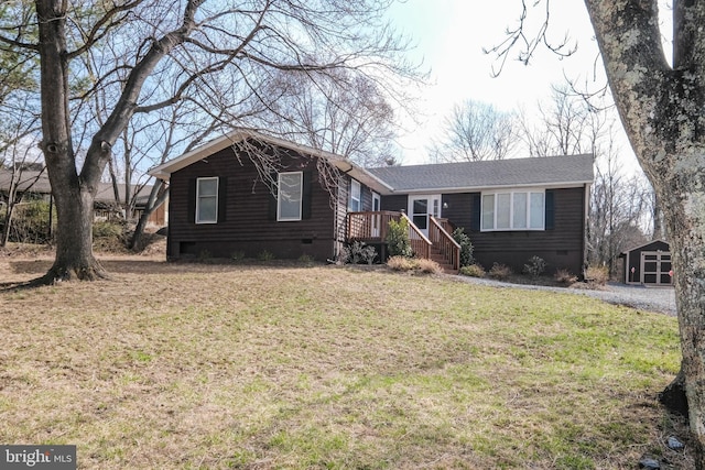 view of front of property featuring a front lawn, an outdoor structure, and crawl space