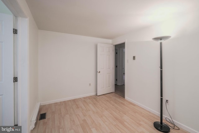 unfurnished bedroom featuring light wood-style floors, visible vents, and baseboards