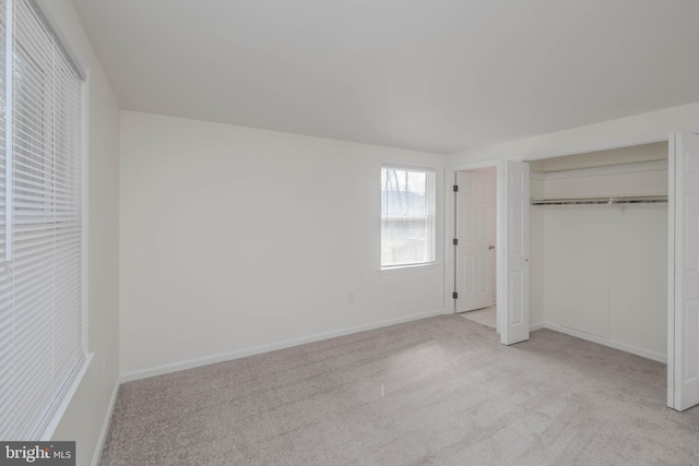 unfurnished bedroom with a closet, carpet flooring, and baseboards