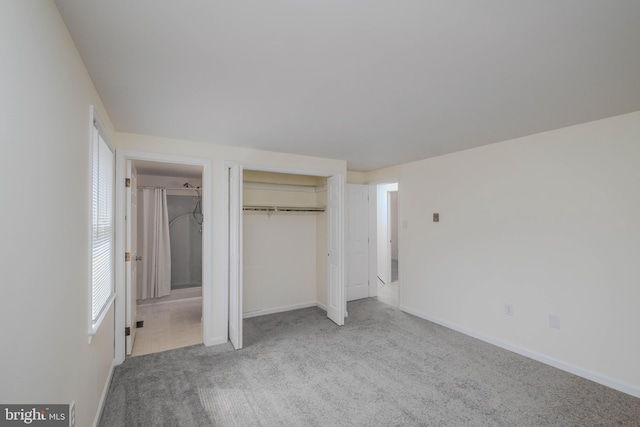 unfurnished bedroom featuring a closet, baseboards, and carpet