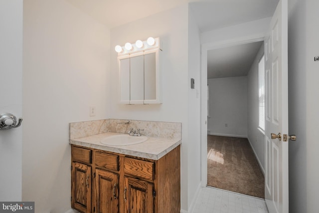 bathroom featuring tile patterned floors, baseboards, and vanity