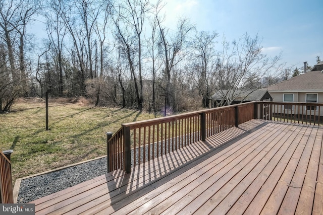 wooden deck featuring a lawn