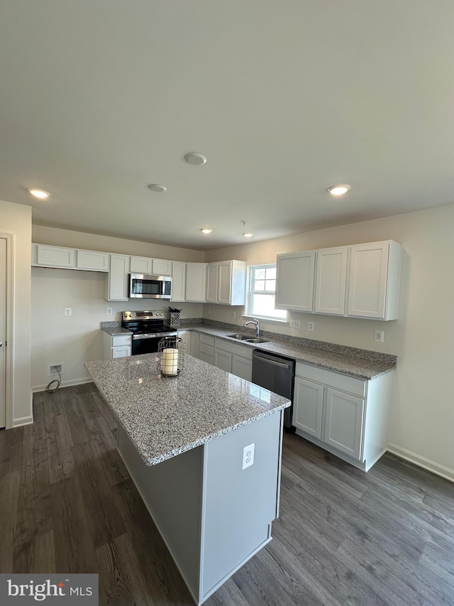 12 Chase Cir, Elkton, MD 21921 - kitchen featuring white cabinets, stainless steel appliances, dark wood-type flooring, a sink, and light stone counters