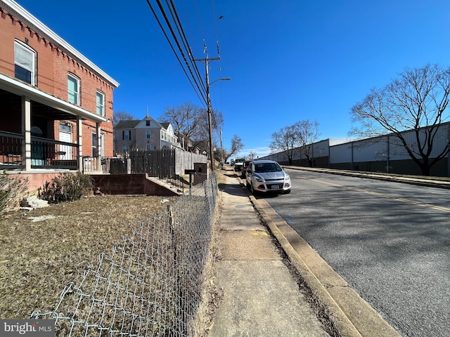 view of street with curbs, street lights, and sidewalks