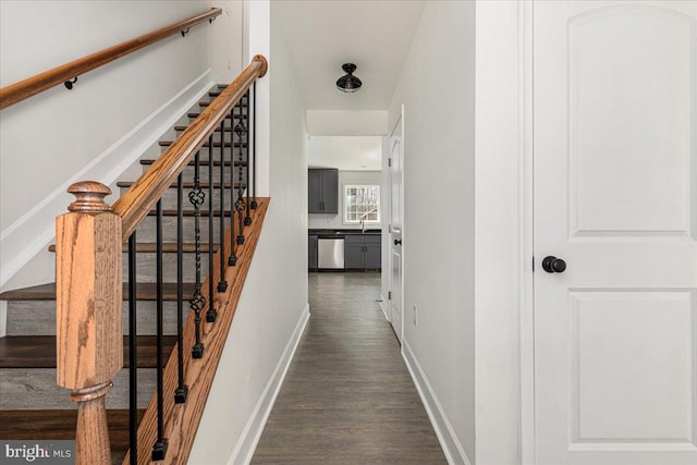 stairs with baseboards and wood finished floors