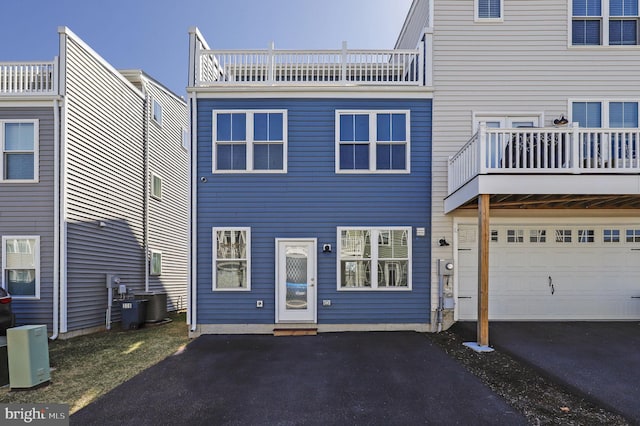back of house featuring a garage and driveway