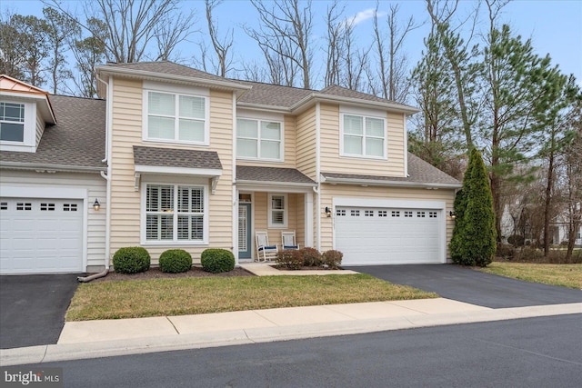 view of front of house featuring aphalt driveway and a shingled roof