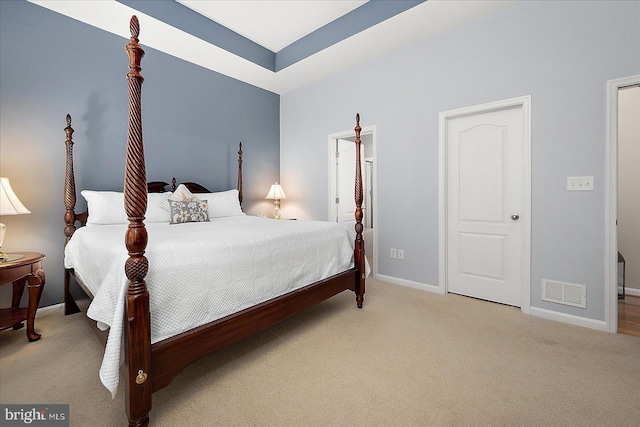 carpeted bedroom featuring baseboards and visible vents