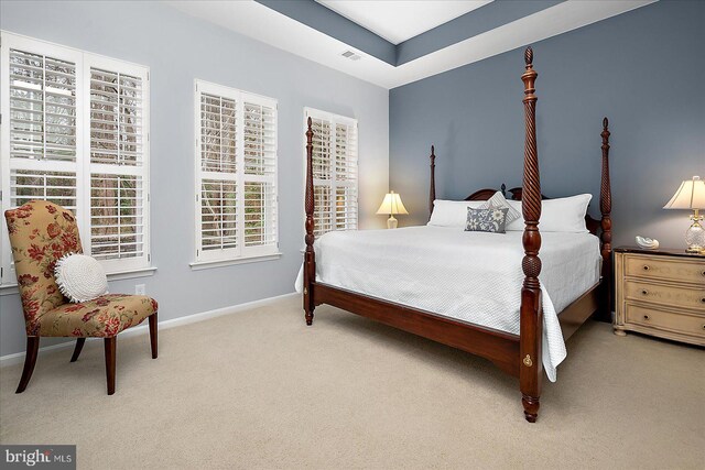 carpeted bedroom with visible vents and baseboards