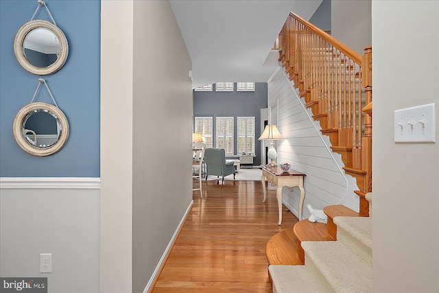 stairway with baseboards and wood finished floors