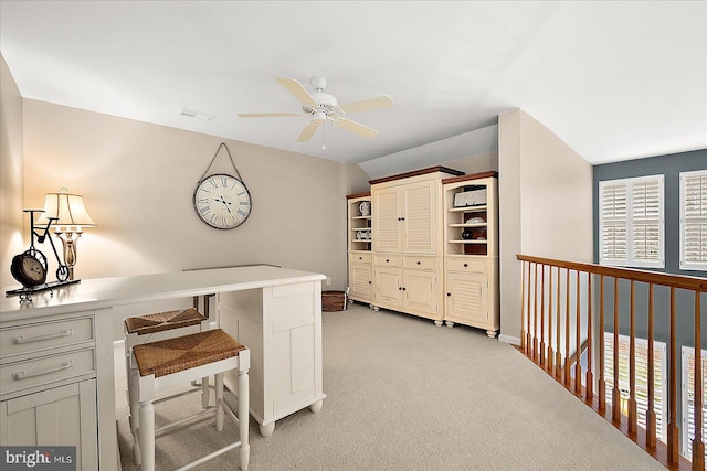 office space with visible vents, light colored carpet, and a ceiling fan