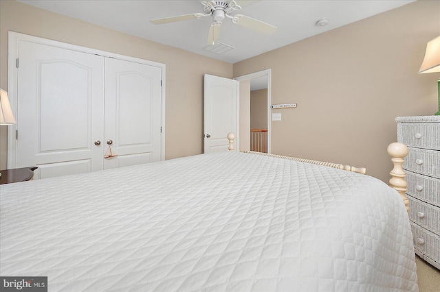 bedroom with a closet, visible vents, and ceiling fan