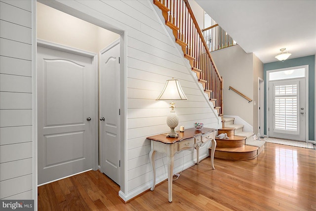 foyer entrance featuring stairway and wood finished floors