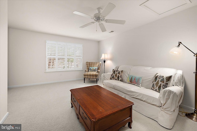 carpeted living area featuring visible vents, baseboards, and a ceiling fan