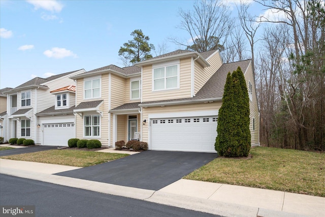 view of front facade with aphalt driveway, an attached garage, a front lawn, and roof with shingles