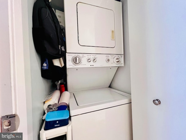 clothes washing area with stacked washer and dryer