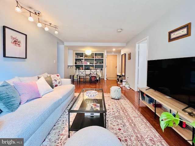 living area featuring a textured ceiling and wood finished floors