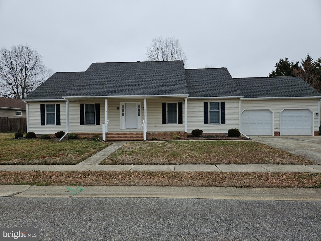 view of front of property with an attached garage, a shingled roof, a porch, a front yard, and driveway