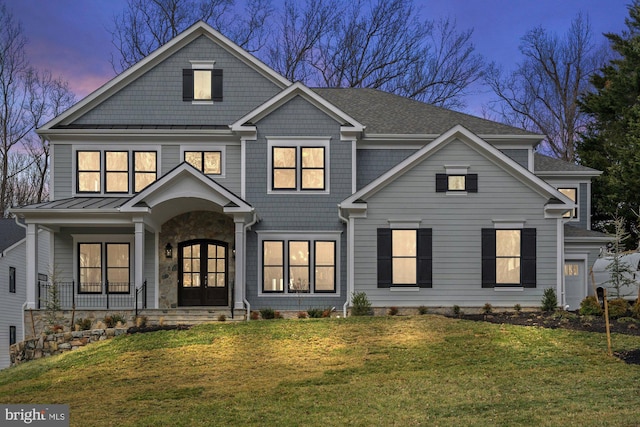 view of front of home with french doors and a front lawn