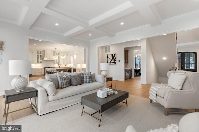 living room featuring recessed lighting, beamed ceiling, coffered ceiling, and an inviting chandelier