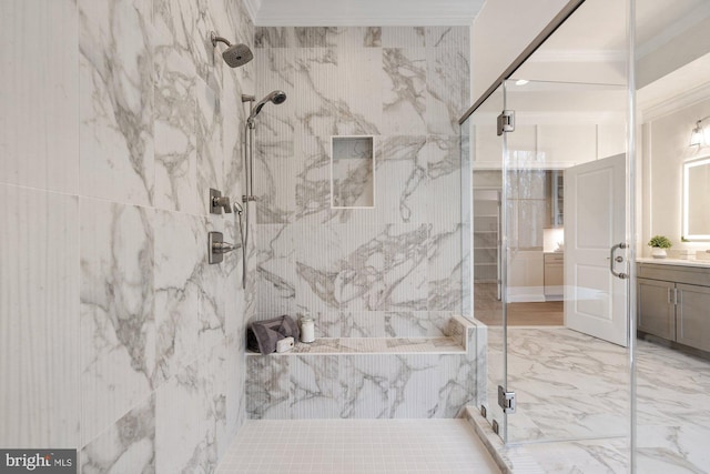 bathroom with a marble finish shower, marble finish floor, vanity, and crown molding