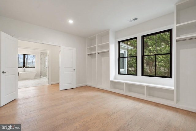 interior space featuring light wood-style floors and visible vents