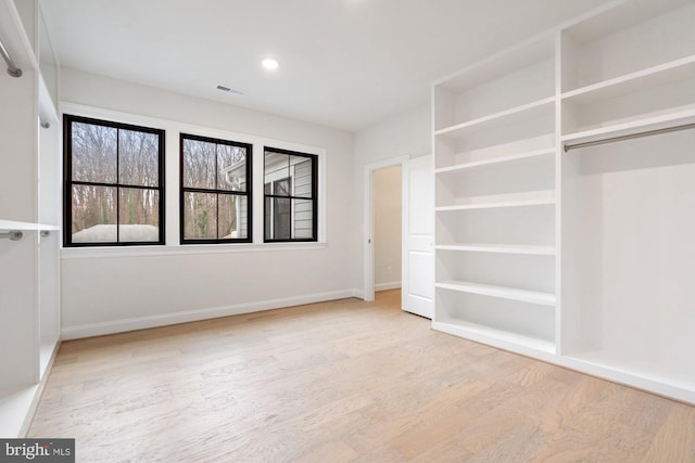 unfurnished bedroom with recessed lighting, visible vents, baseboards, and wood finished floors