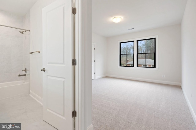 bathroom featuring baseboards, visible vents, and shower / bathtub combination