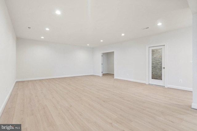 spare room featuring recessed lighting, baseboards, and light wood finished floors